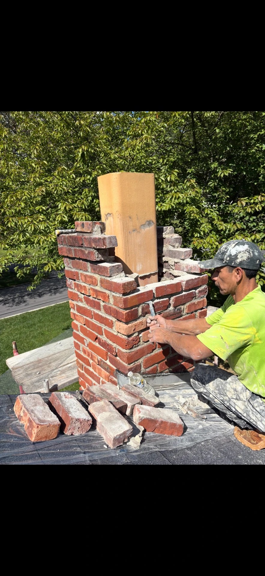 Mason repointing brick mortar joints on a historic Media, PA building